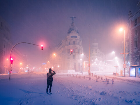 Snowy night in downtown Madrid with illuminated streets