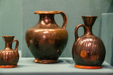 Antique ceramic decorative amphora on a white background. Clay jugs and a pot, a set of ancient utensils for drinking wine, water or milk. High quality photo