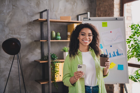 Photo of nice young woman office worker coffee samrt phone wear shirt loft interior business center indoors