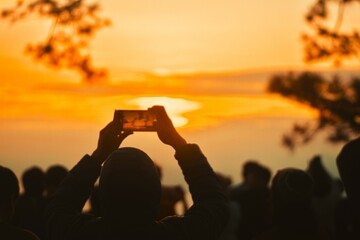 Silhouette of Person Capturing Sunrise on Smartphone, Scenic Golden Hour Photography, Sunrise Enthusiasts in Nature, Stock Image for Travel Blogs, Adventure Tourism, and Outdoor Lifestyle.