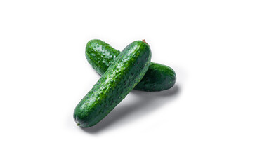 Three cucumbers are cut in half and placed on a white background. The cucumbers are fresh and green, and they are arranged in a way that makes them look like they are ready to be eaten