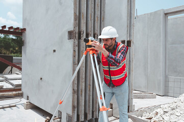 Architectural surveying engineers use data transfer equipment on outdoor construction sites during surveying. Surveyor’s telescope at construction