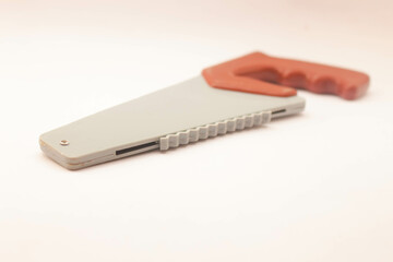 Toy saw on white background