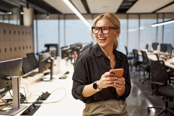 A Smiling Professional Woman in a Modern Office Environment Working with Confidence and Style