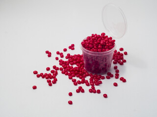 Red masterbatch granules isolated on white background, color pigment carrier polymer in plastics...