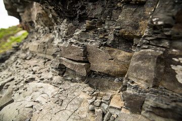 Here is a detailed close up image of a rocky wall featuring many rocks