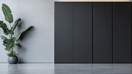 The setup features a stylish black wardrobe that exemplifies modern minimalist design, positioned against a soft gray wall. A lush potted plant adds a natural touch to the decor