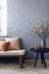 Cozy living room corner featuring a minimalist sofa and decorative table with natural elements in soft neutral tones