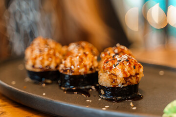 Baked Japanese sushi or rolls on a plate