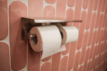 Toilet paper on the stand.