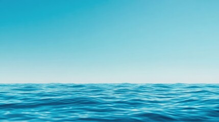 Fototapeta premium Tranquil sea view with shimmering water under a clear blue sky, perfect for relaxation and nature-themed projects.