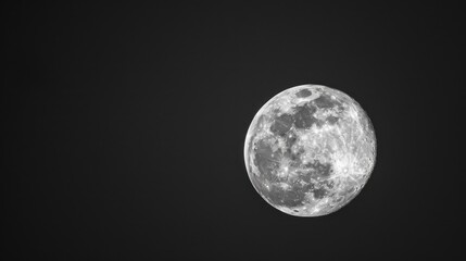 Obraz premium Full moon against a black night sky. Lunar and space exploration concept.