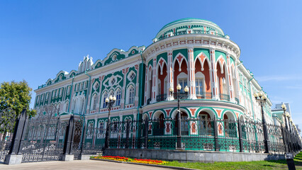 Sevastyanov's House or House of Trade Unions on shore of city pond formed by dam on Iset River. Historical and architectural monument located in Yekaterinburg, Russia