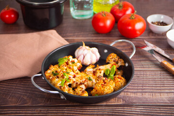 Cauliflower steak with spices and herbs cooked in the oven. Healthy vegan organic cuisine.