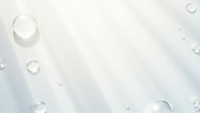 白い背景の上に輝く光を乱反射したクリアな水の雫　Clear water drops with diffused reflection of shining light on a white background