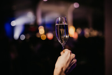 person holding champagne glass in a event