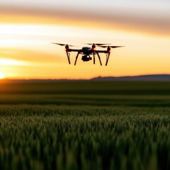 a drone flying over a field at sunset