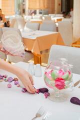 Close shot, no face for arranging tableware in restaurant by waiter