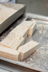 Shot for coating cheese in breadcrumbs in restaurant kitchen