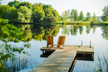 beautiful lake view with wooden dock and relaxation chairs