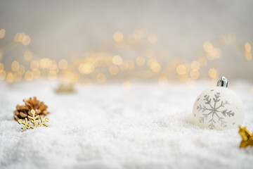 Christmas Holiday background with snow, fir tree and decorations with christmas light behind....