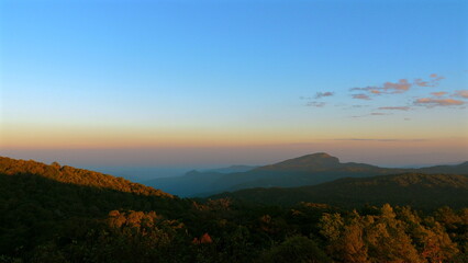 Scenic mountain landscape at sunrise with vibrant colors and clear skies, perfect for travel and nature themes, representing tranquility and peacefulness. Outdoor Adventure and Serenity