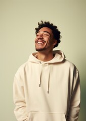Fototapeta premium A happy mixed race british man wear cream hoodie sweatshirt laughing adult.
