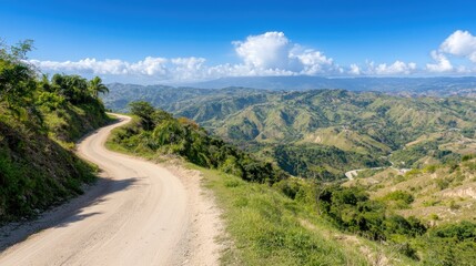 Fototapeta premium Experience the serenity of a winding road nestled in a dense forest, with vibrant green vegetation and majestic mountains stretching into the distance