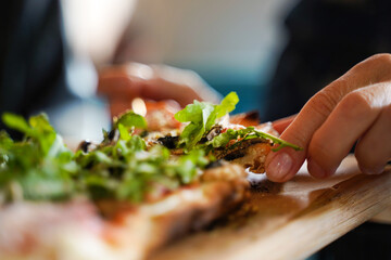 Slice of pizza with arugula close-up