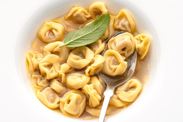 Tortellini with sage leaf. Winter Italian cuisine. Close-up