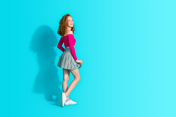 Full body profile portrait of nice young girl empty space wear top isolated on turquoise color background