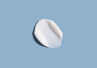 Cosmetic smear of cream texture on a blue background. Skin care.