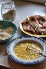 The process of preparing pork chops or Wiener schnitzel - flour, egg, breadcrumbs