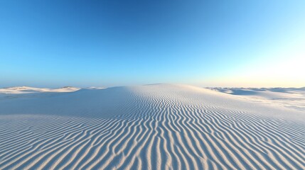 The vast sand dunes create a mesmerizing pattern under the clear blue sky, with gentle winds shaping their soft surfaces, offering a tranquil atmosphere at twilight