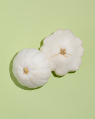 Whole Summer White pattypan Squash on green background