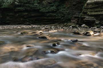 Vibrant Waters Cutting Through a Rocky Forest