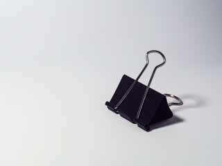 Black metal paperclip on a white background