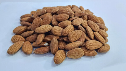 Raw Almond nuts isolated on white background closeup selective focus