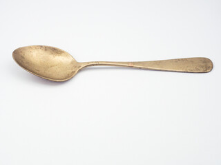 Ancient copper spoon on a white background