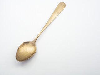 Ancient copper spoon on a white background