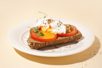 Plate of tasty sandwich with egg on yellow background