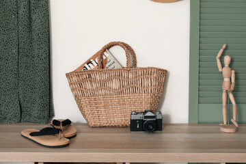 Different beach accessories on commode in modern living room