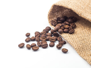 Roasted coffee beans with burlap cloth on white background