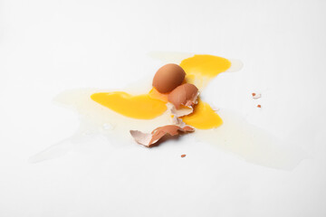 Raw broken egg on white background, top view
