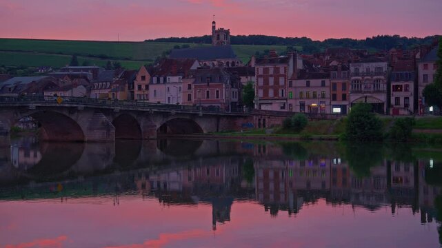 Twilight time illumination Joigny city famous. Yonne riverside downtown panorama. Sunset view of river