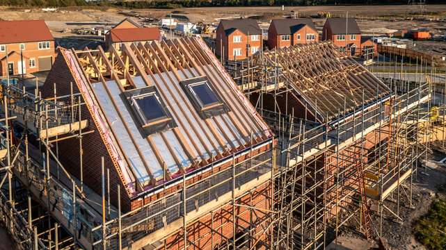 Aerial view of a roof under construction with attic room and skylight window on a new build housing development