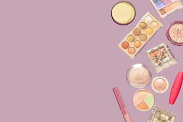 Different cosmetic products flying on lilac background