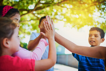 Group, high five and students with team building, school and support with motivation, game or cooperation. Outdoor, friends and kids with hand gesture, education or collaboration for children and joy