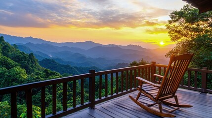 Naklejka premium A tranquil rocking chair on a deck overlooks stunning mountains at sunset, creating a peaceful and serene atmosphere.