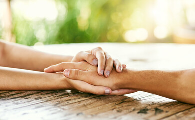 People, closeup and holding hands for comfort, support and trust with emotional compassion and...